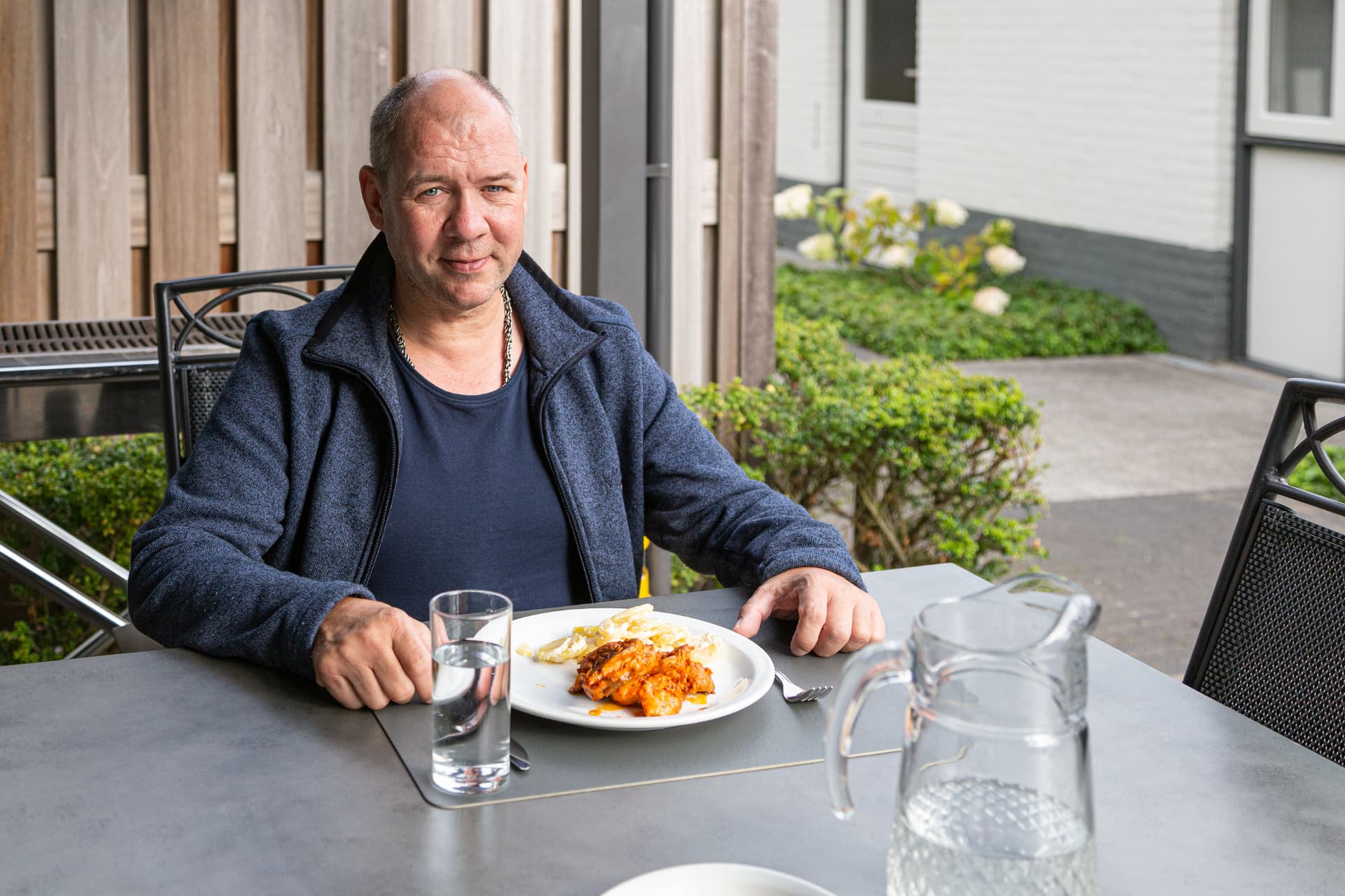 Bewoner aan tafel met maaltijd